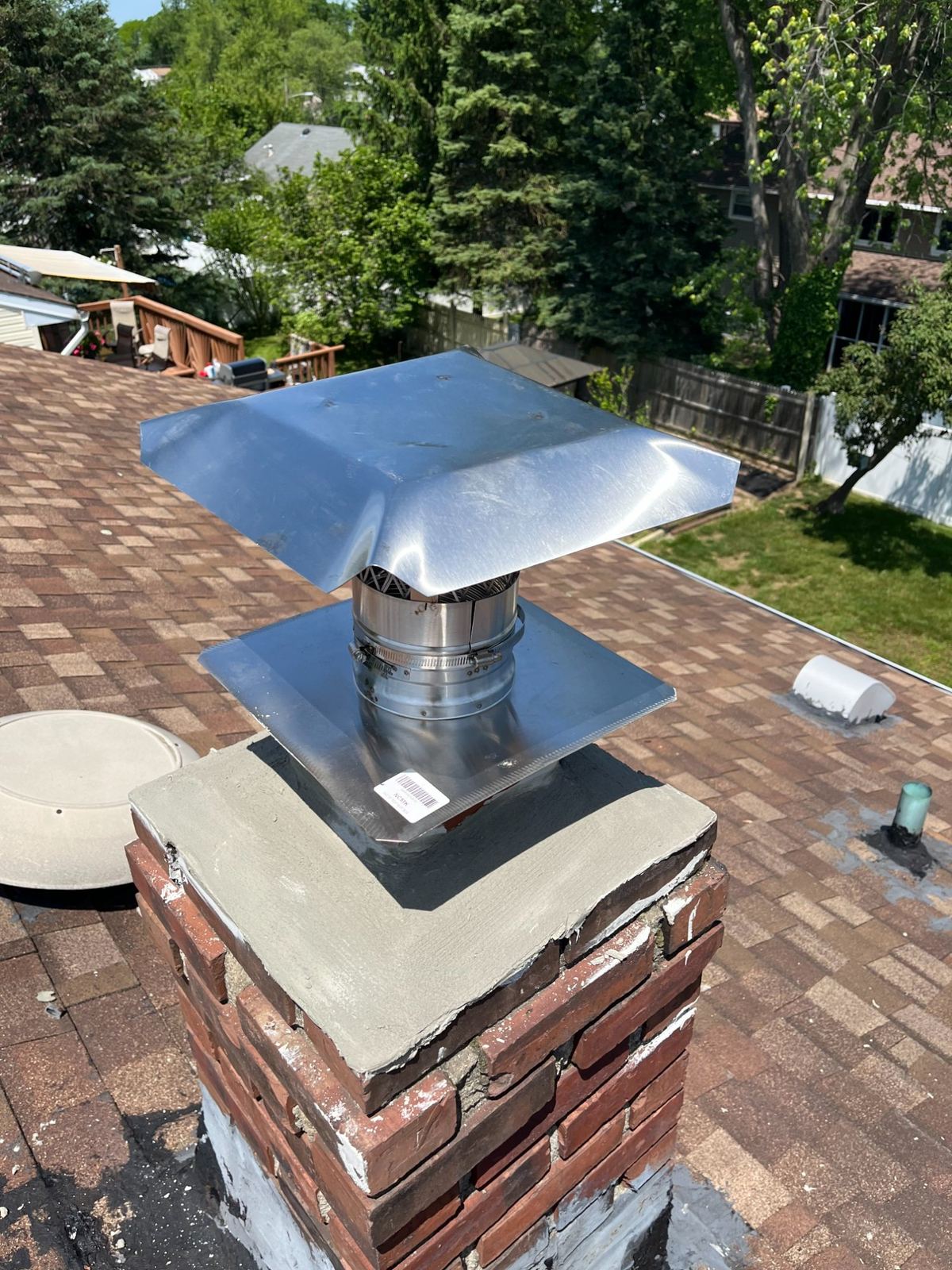 Chimney liner cap installed on brick chimney in Boston